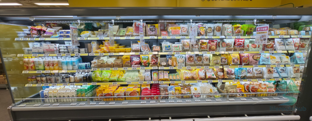 Korean Grocery Store 101: How to Shop at E-mart in South Korea Instant foods and dairy products such as tteokbokki, fish cakes, and milk on E-mart store shelves
